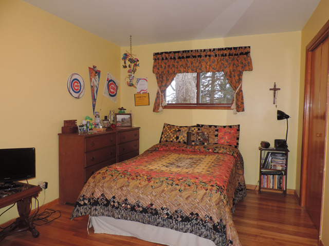 19610 West Manhattan Road Elwood, IL 60421 - Photo 6 of 17 a bed sitting in a bedroom next to a window with wooden floor