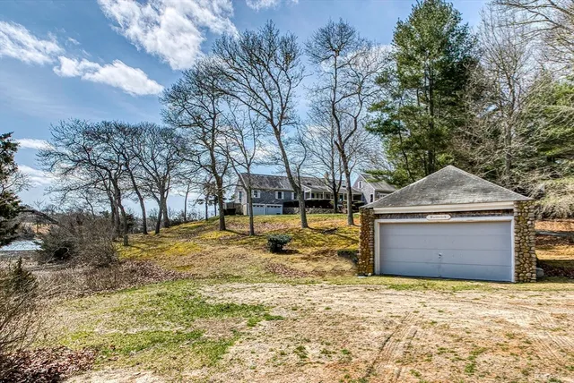 a view of house with backyard and outdoor seating