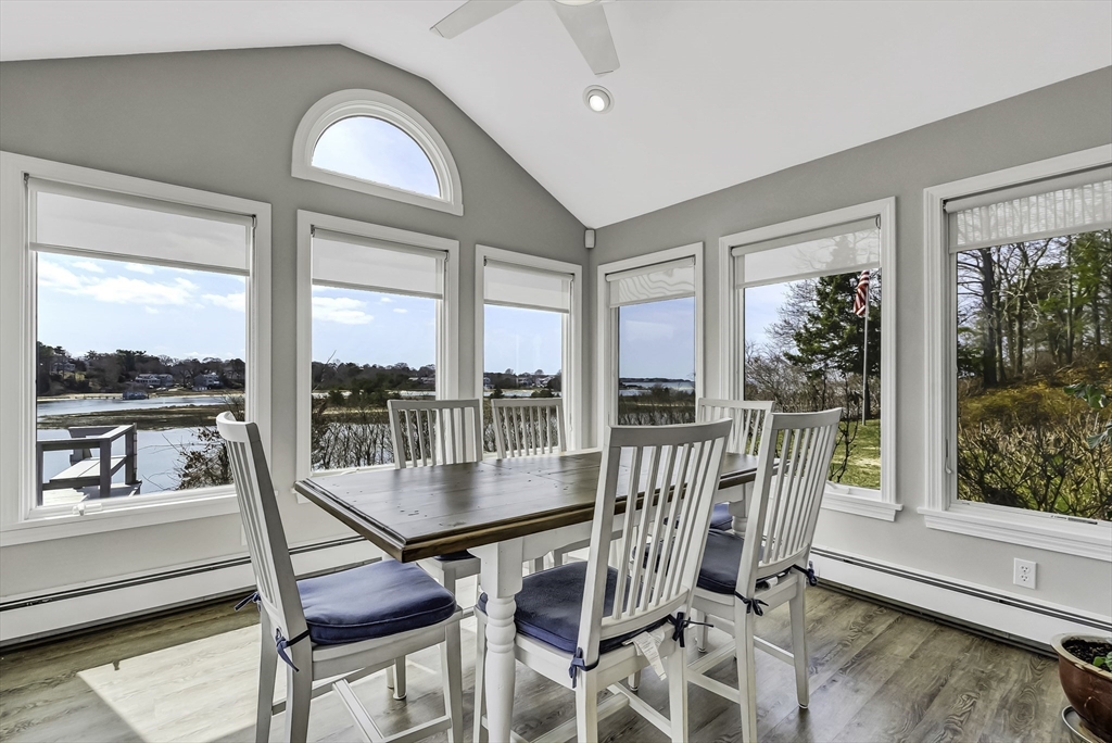31 Baxendale Road Bourne, MA 02534 - Photo 15 of 35 a view of a dining room with furniture large windows and wooden floor