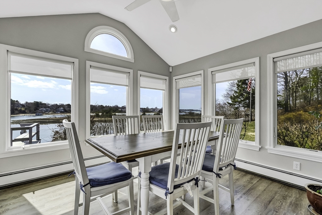31 Baxendale Road Bourne, MA 02534 - Photo 16 of 36 a view of a dining room with furniture large windows and wooden floor