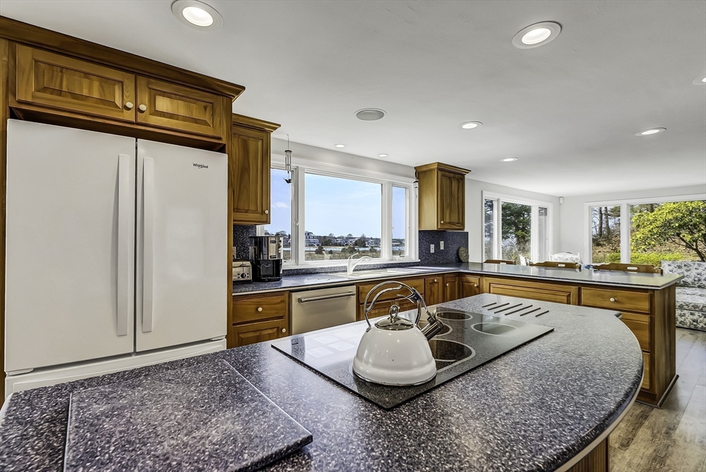 31 Baxendale Road Bourne, MA 02534 - Photo 21 of 36 a kitchen with stainless steel appliances granite countertop a sink stove and refrigerator