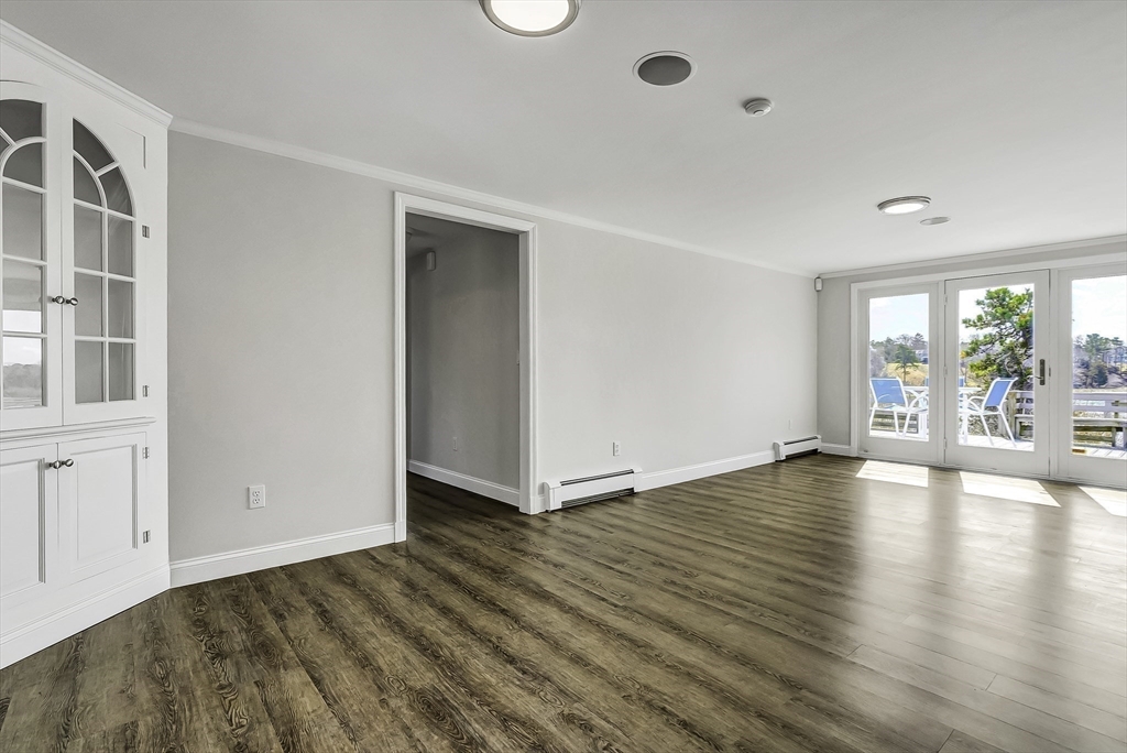 31 Baxendale Road Bourne, MA 02534 - Photo 23 of 35 wooden floor in an empty room with a window