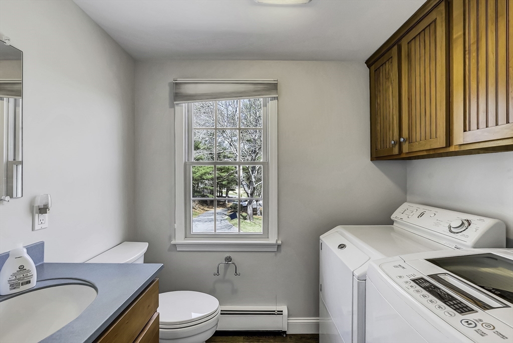 31 Baxendale Road Bourne, MA 02534 - Photo 25 of 36 a bathroom with a granite countertop sink a toilet and mirror
