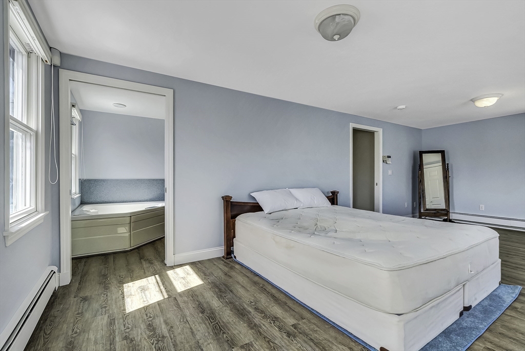 31 Baxendale Road Bourne, MA 02534 - Photo 30 of 36 a spacious bedroom with a bed and a large window