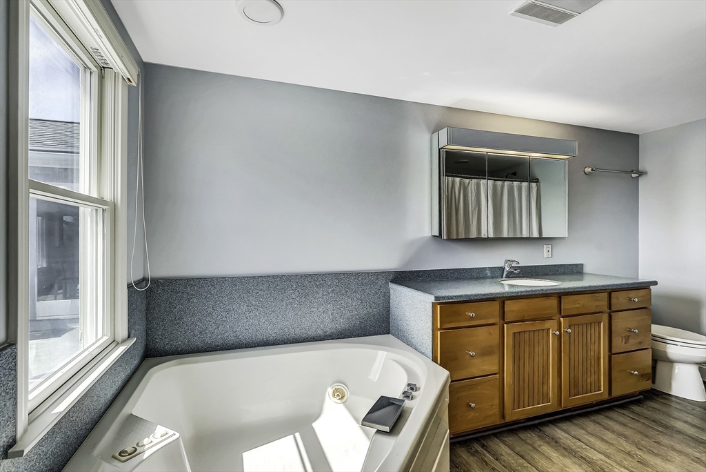 31 Baxendale Road Bourne, MA 02534 - Photo 31 of 35 a bathroom with a tub sink and mirror