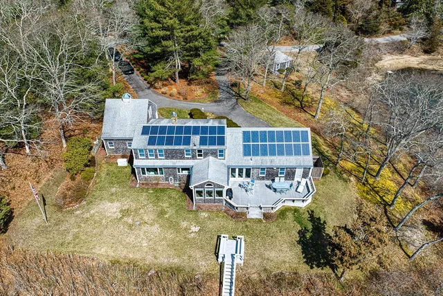 a view of swimming pool with outdoor seating and covered with trees