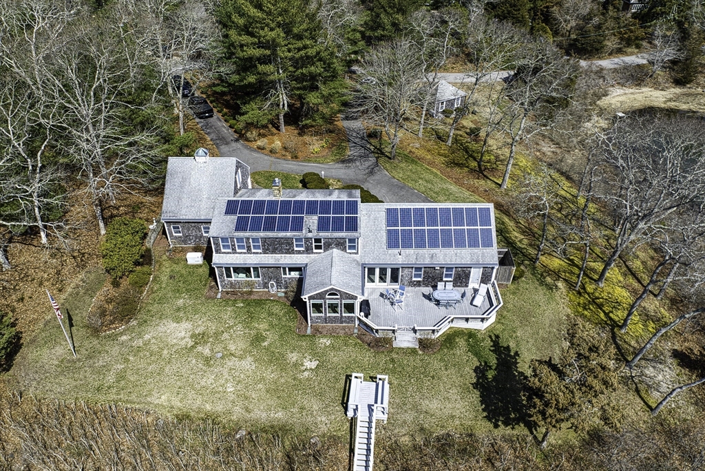 31 Baxendale Road Bourne, MA 02534 - Photo 9 of 35 a view of swimming pool with outdoor seating and covered with trees