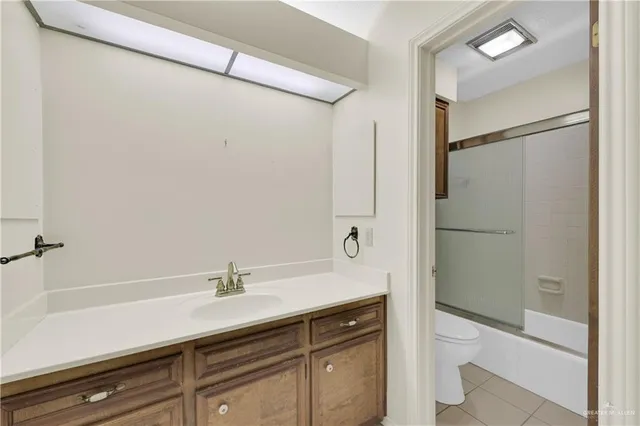 a bathroom with a shower sink and mirror