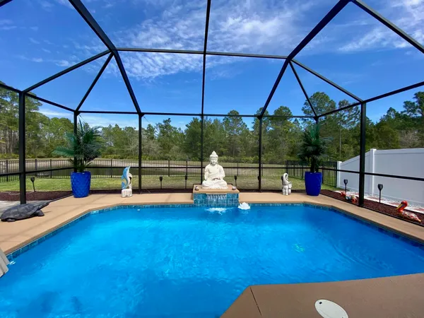 an aerial view of a house with a swimming pool and outdoor space