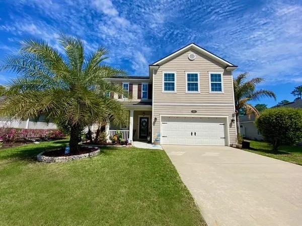 a front view of a house with a yard and garage