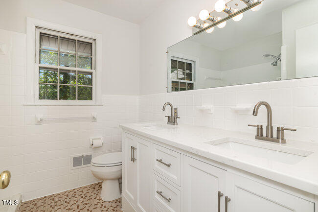 3610 Randolph Road Durham, NC 27705 - Photo 11 of 29 a bathroom with a sink a toilet and a mirror