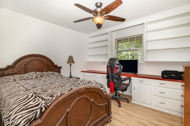 3610 Randolph Road Durham, NC 27705 - Photo 12 of 29 a bedroom with a bed and a chandelier