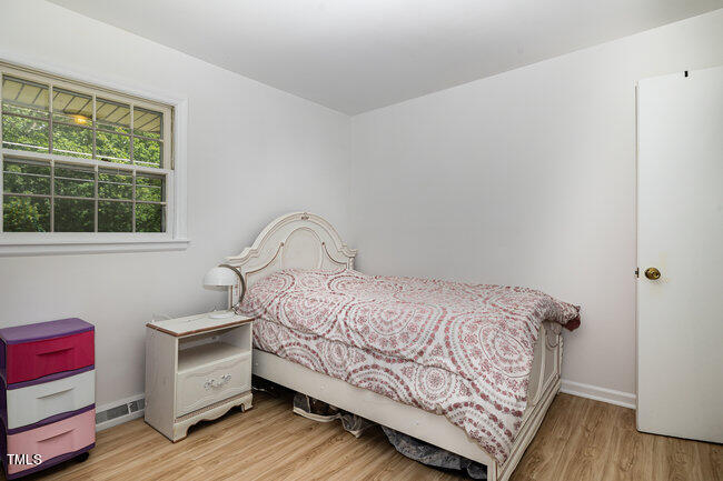3610 Randolph Road Durham, NC 27705 - Photo 14 of 29 a bedroom with a bed and a window