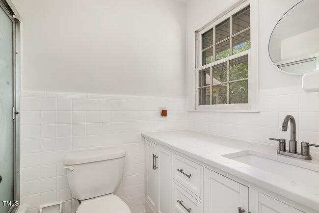 3610 Randolph Road Durham, NC 27705 - Photo 15 of 29 a bathroom with a sink toilet and a window