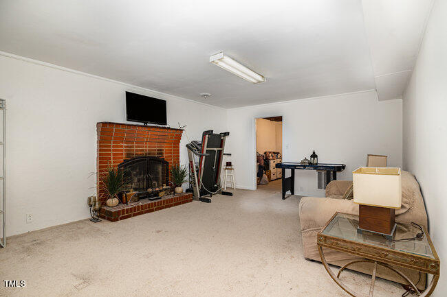 3610 Randolph Road Durham, NC 27705 - Photo 16 of 29 a living room with furniture a flat screen tv and a fireplace