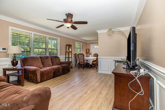 3610 Randolph Road Durham, NC 27705 - Photo 3 of 29 a living room with furniture a large window and wooden floor