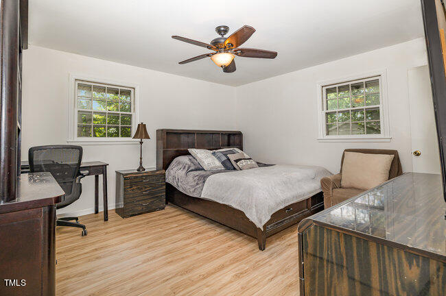 3610 Randolph Road Durham, NC 27705 - Photo 8 of 29 a bedroom with two beds and a chandelier
