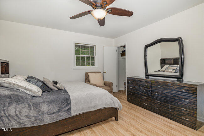 3610 Randolph Road Durham, NC 27705 - Photo 9 of 29 a bedroom with a bed a dresser and a large mirror
