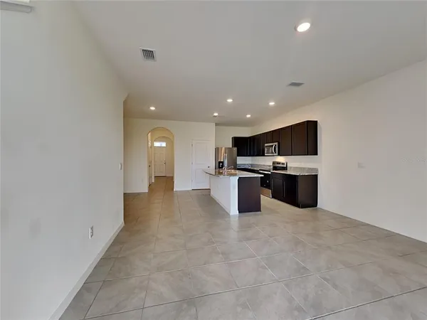 a view of kitchen with stainless steel appliances a refrigerator and a stove top oven