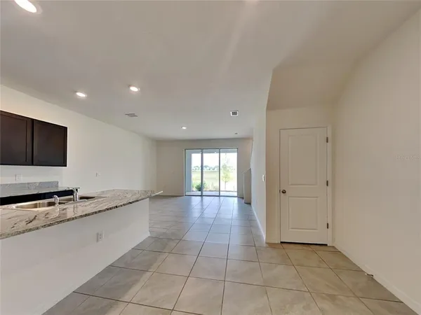 a view of a kitchen with an empty space and a window