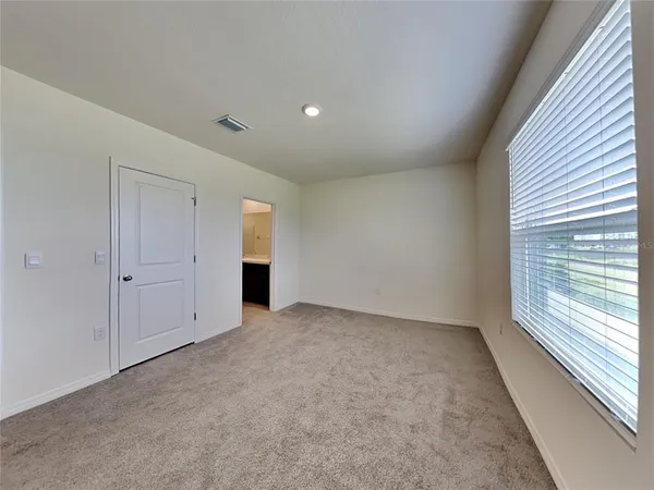 a view of an empty room and a window