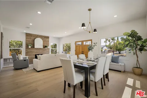 a dining room with furniture and wooden floor