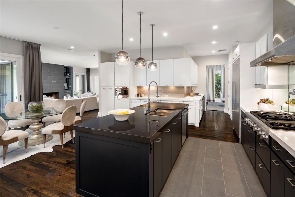 5811 Meletio Lane Dallas, TX 75230 - Photo 11 of 31 a kitchen with stainless steel appliances granite countertop a sink a stove and a refrigerator
