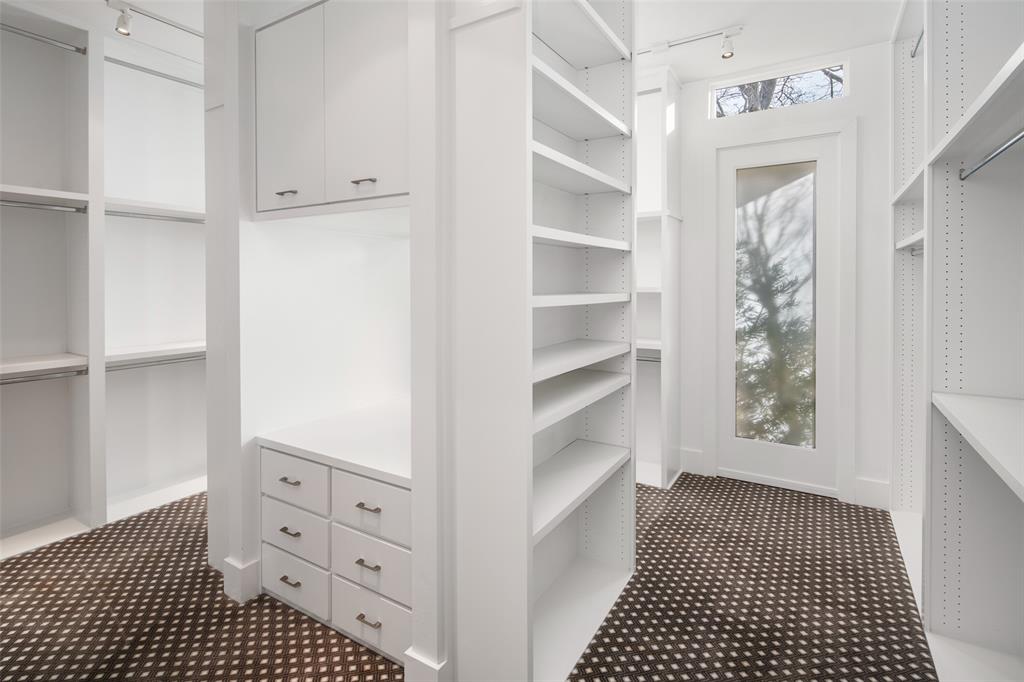 5811 Meletio Lane Dallas, TX 75230 - Photo 15 of 31 a view of a hallway with closet and cabinet