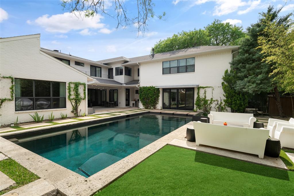 5811 Meletio Lane Dallas, TX 75230 - Photo 27 of 31 a view of a house and a swimming pool with a couches chairs and large tree
