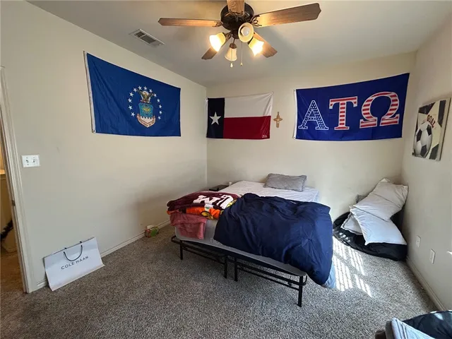 a living room with furniture and a bookshelf