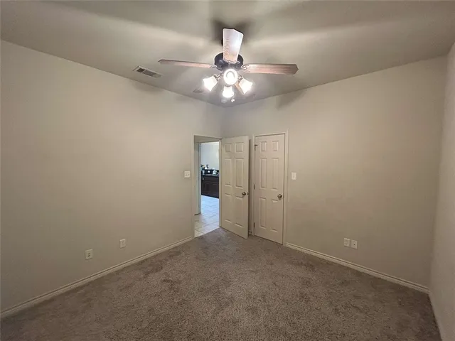 en empty room with fan and window