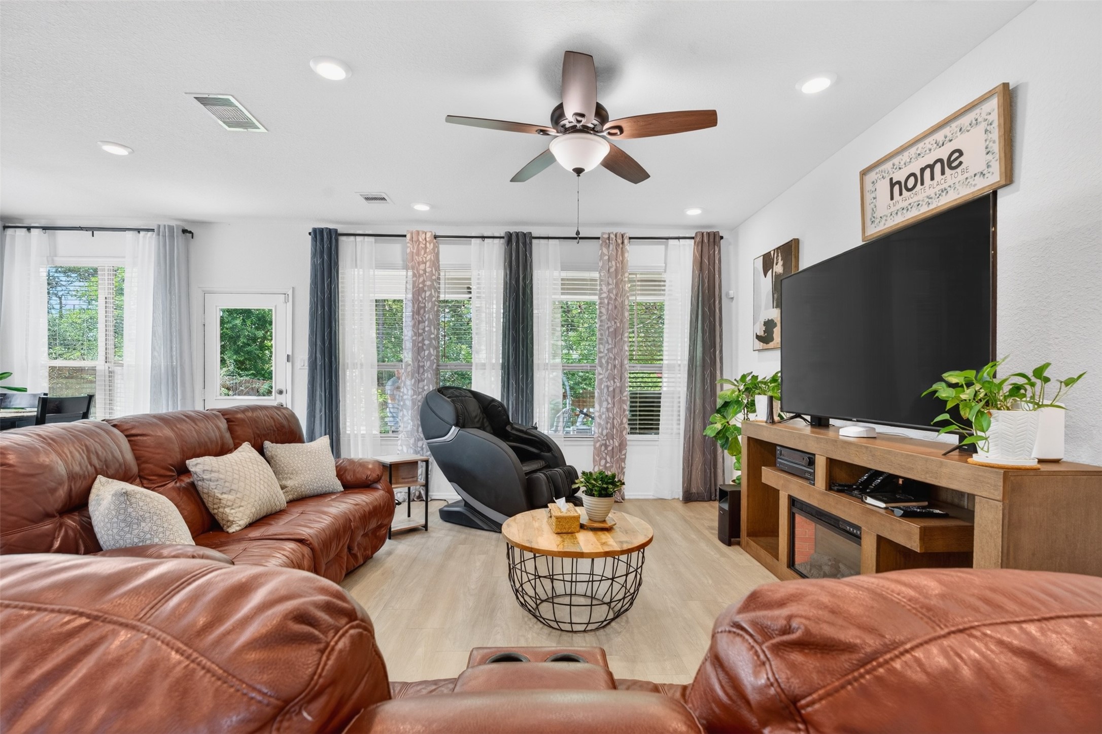 2832 Mistygate Court Conroe, TX 77301 - Photo 4 of 50 Spacious living room featuring a beautiful wall of windows that fills the space with natural light while overlooking the backyard.