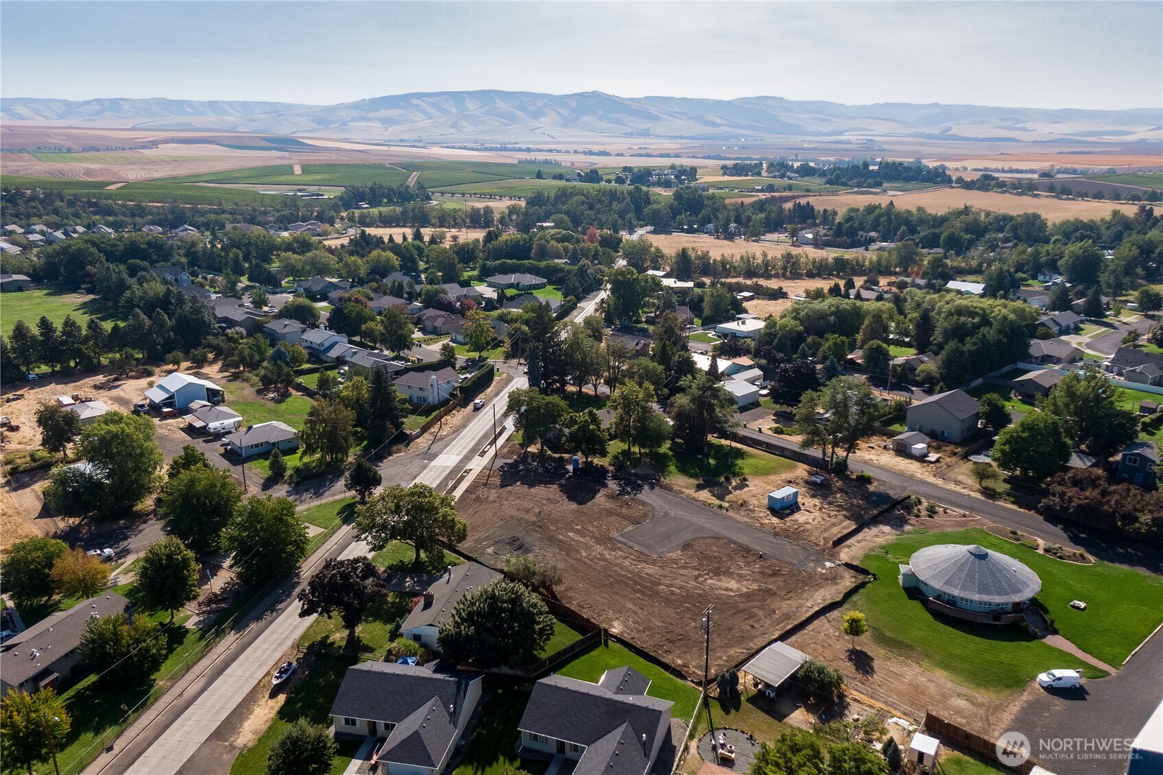 an aerial view of residential houses and outdoor space