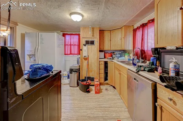 a kitchen with stainless steel appliances a stove refrigerator sink and cabinets