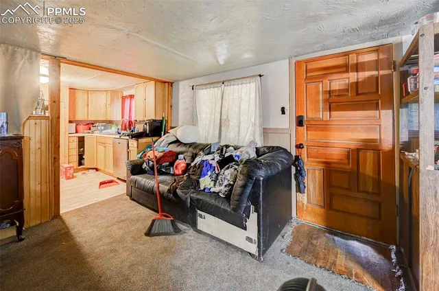 a living room with furniture gym equipment and large window