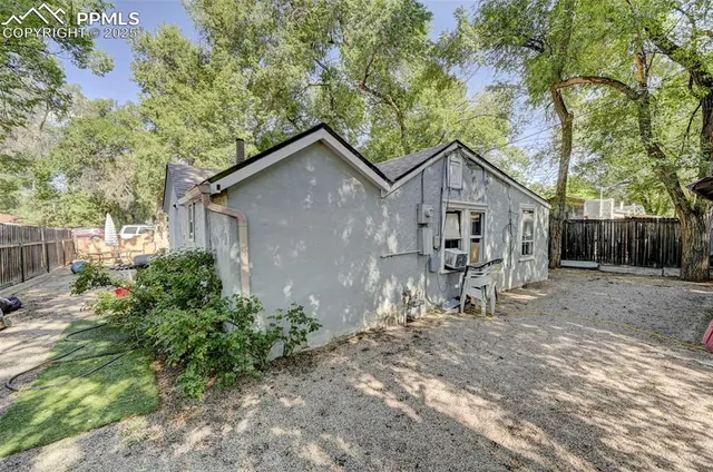 a view of a house with a yard and sitting area