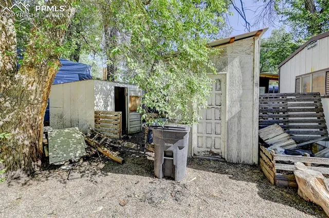 a view of a chairs and table in the backyard