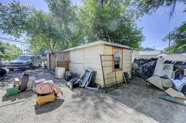 a view of backyard with outdoor seating and trees
