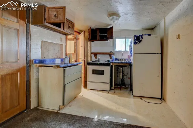 a kitchen with stainless steel appliances granite countertop a refrigerator and a stove