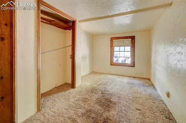 a view of a room with wooden floor and closet