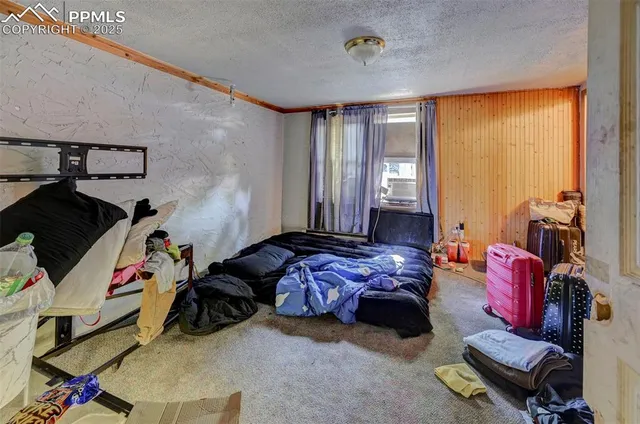 a bedroom with bed and a window