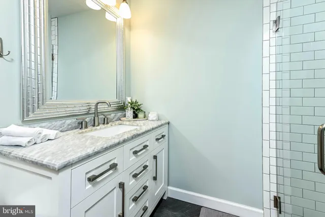 a spacious bedroom with a bed and a large window