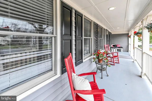 a view of a chairs and table in the balcony