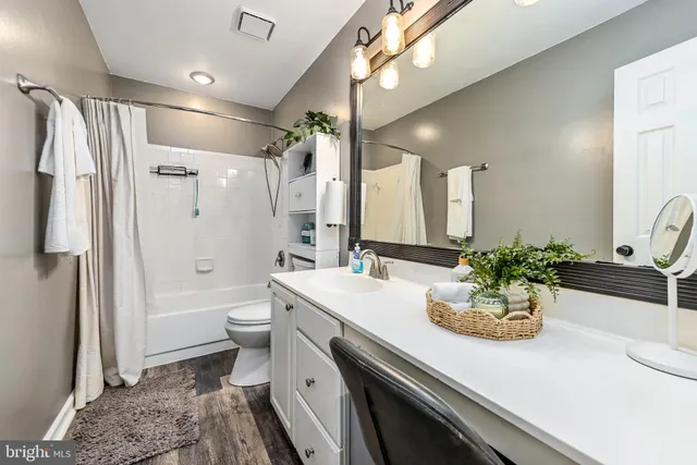 a view of a hallway and a livingroom with furniture
