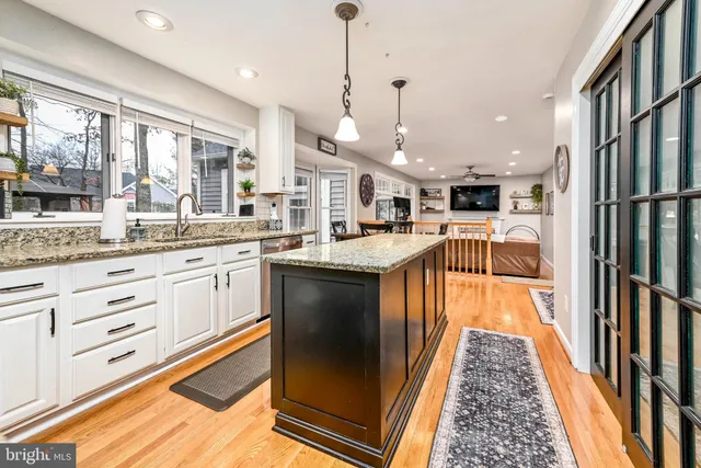 a kitchen with stainless steel appliances granite countertop a stove refrigerator sink and microwave