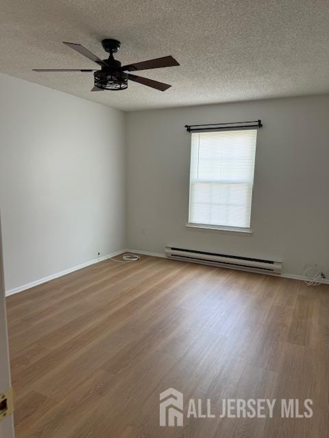 525 B Belford Road Monroe Township, NJ 08831 - Photo 6 of 8 an empty room with wooden floor fan and windows
