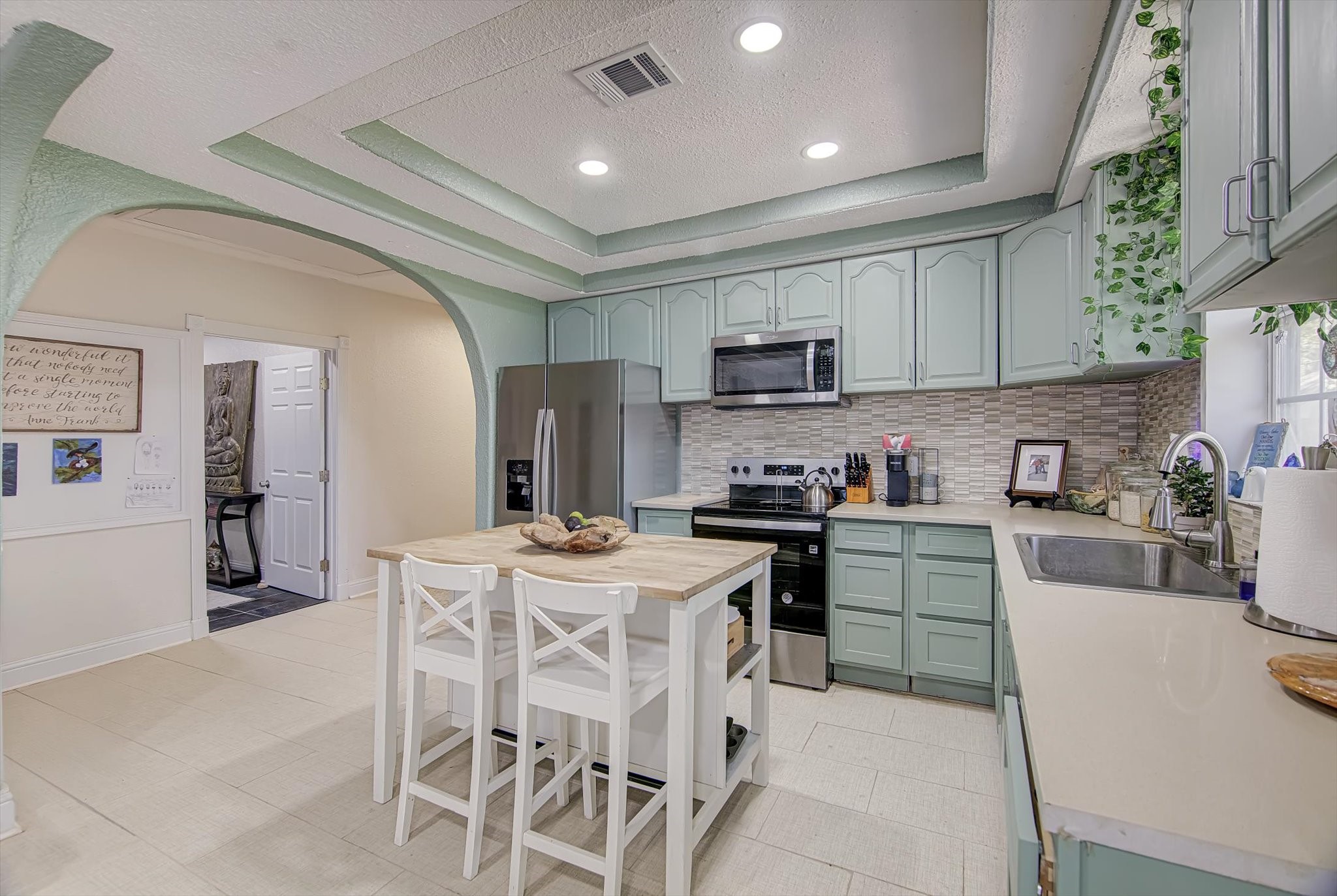 4123 Crosby Cedar Bayou Road Baytown, TX 77521 - Photo 11 of 26 a kitchen with stainless steel appliances kitchen island granite countertop a sink a stove a refrigerator cabinets and a dining table with chairs
