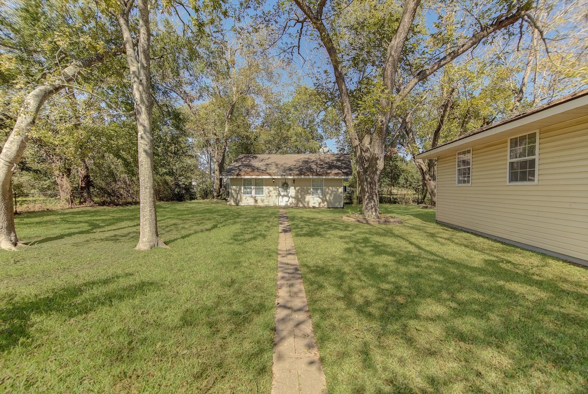 4123 Crosby Cedar Bayou Road Baytown, TX 77521 - Photo 5 of 26 a backyard of a house with lots of green space