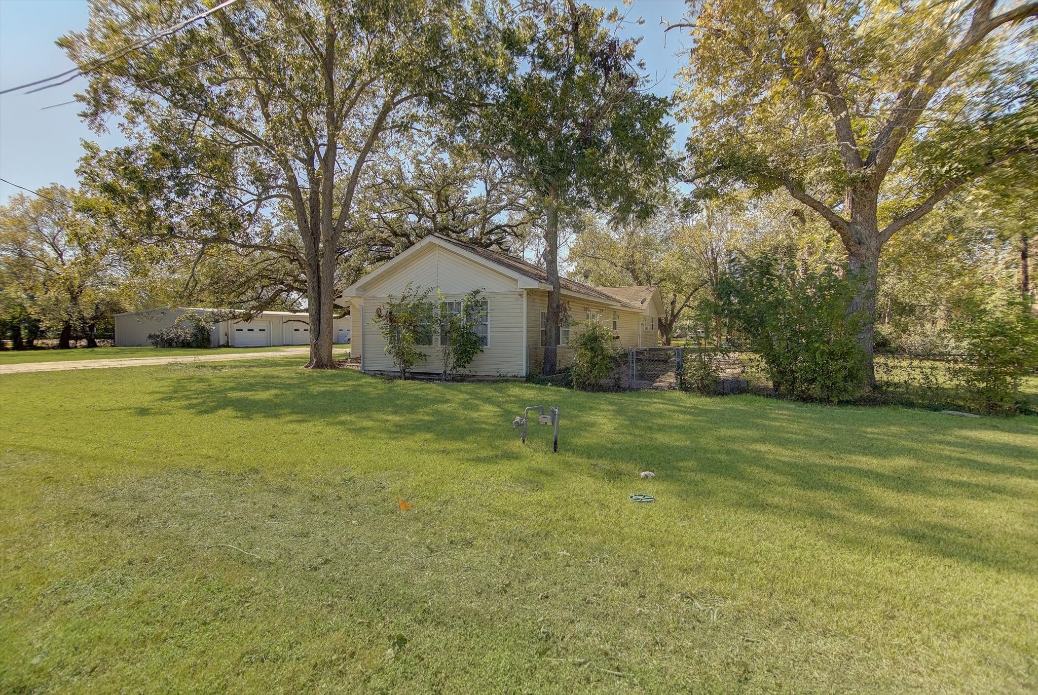 4123 Crosby Cedar Bayou Road Baytown, TX 77521 - Photo 6 of 26 a view of a tree in a yard with a house