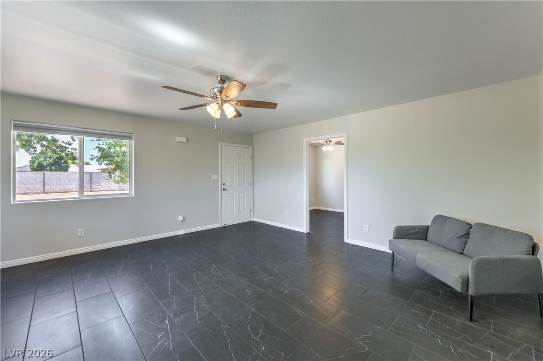 348 Tres Palomas Street Overton, NV 89040 - Photo 30 of 41 A versatile living area features dark tile flooring and a refreshing ceiling fan.